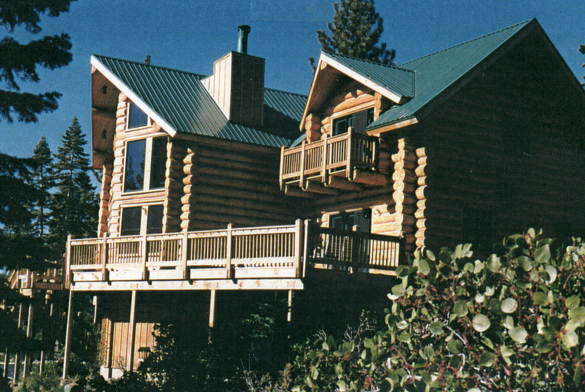 A close-up of the duplex wooden house with metal roofing